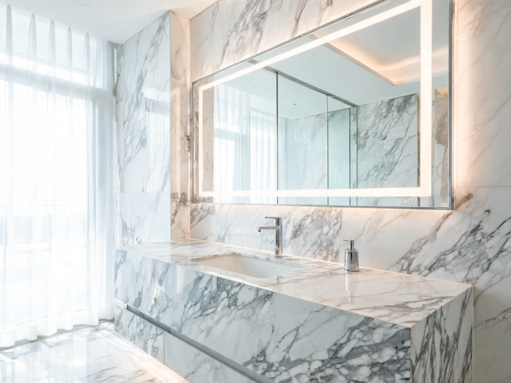 Luxury hotel bathroom featuring Calacatta marble vanity top supplied by Hoàng Kha Stone